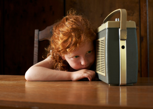 Girl (4-6) listening to radio